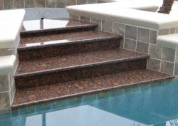 steps made of granite going into a pool