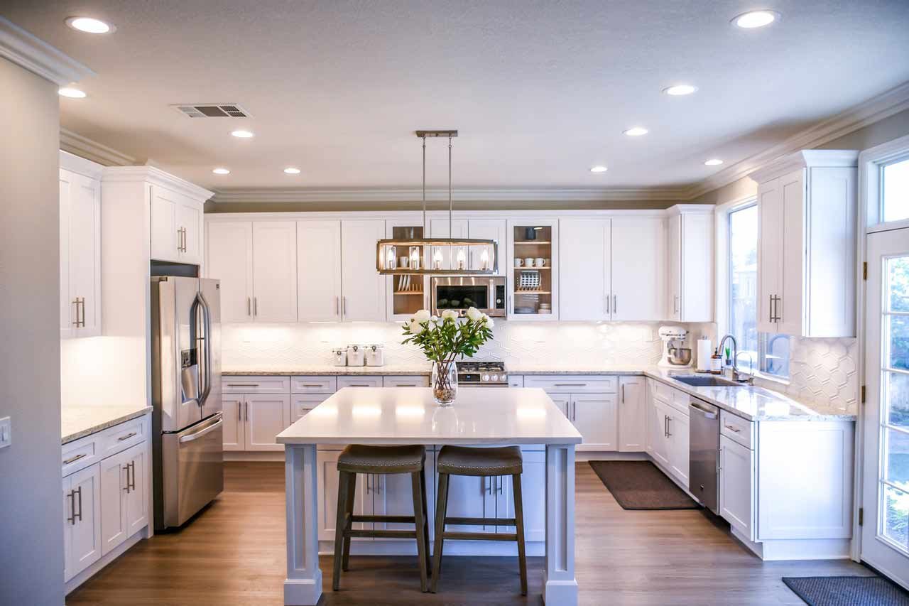 beautiful kitchen with a white aesthetic showing off quartz countertops for the blog, “What is Quartz”